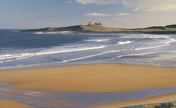 Dunstanburgh Castle overlooking the beach.